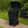 A photograph captures a black wheeled trash can wi